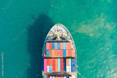 Aerial view and top view. Container ship in pier with crane bridge carries out export  and import business in the open sea. Logistics and transportation © Sunday Stock