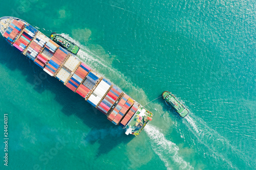 Aerial view and top view. Container ship in pier with crane bridge carries out export  and import business in the open sea. Logistics and transportation © Sunday Stock