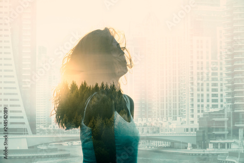 Schilderij op canvas Double exposure with young woman in the modern cityscape and forest