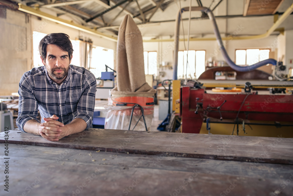 Woodworker thinking of new desings in his workshop Woodworker thinking of new desings in his workshop