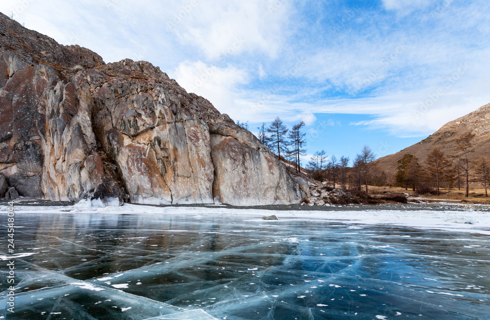 Baikal Lake in the winter. White marble rocks of Sagan-Zaba cliff with ancient rock carvings are the tourists landmark and the famous place of excursions