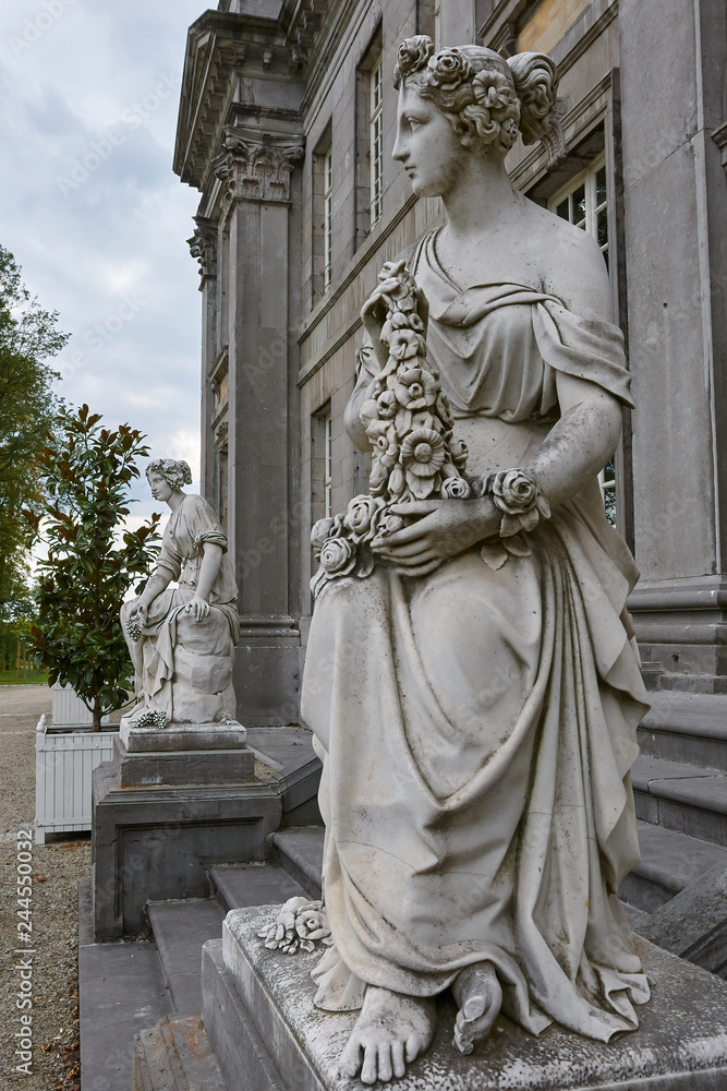 Stone statue of women at a castle entrance
