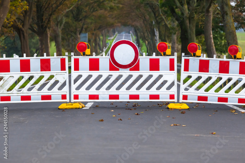 Фотография Closed Forbidden Road / Red and white colored street barrier on closed avenue ro