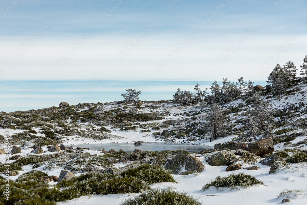 Way of ascent to the lagoons of Peñalara in the mountain range of Madrid covered by snow.