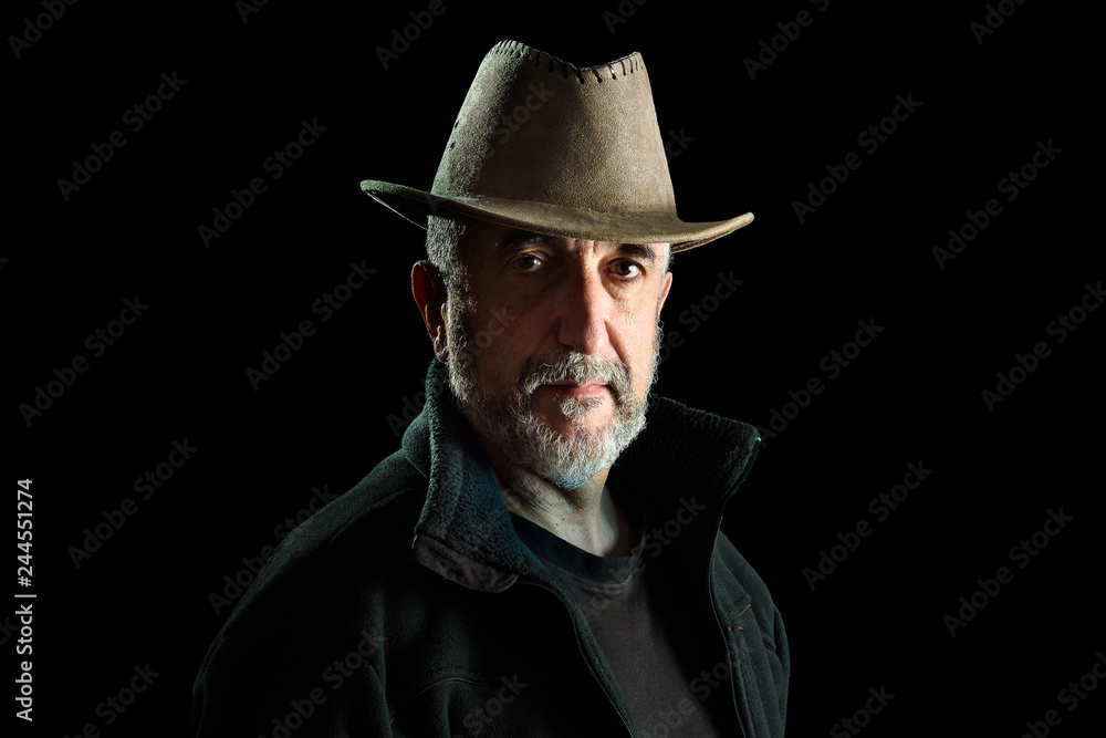 Portrait of adult man with hat, isolated on black background Portrait of adult man with hat, isolated on black background