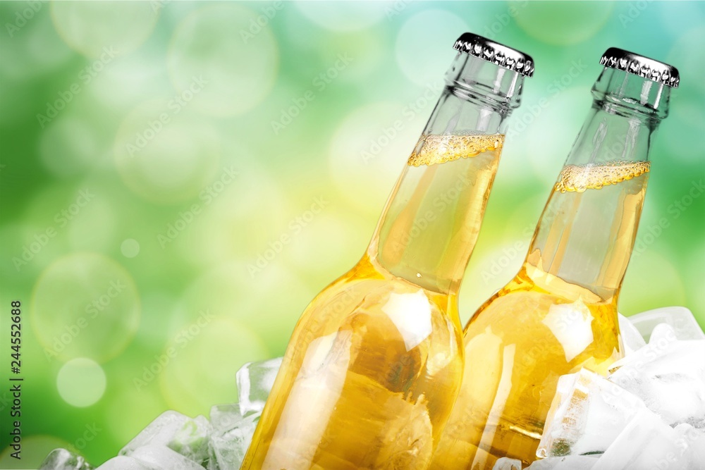 Bottles of cold and fresh beer with ice isolated on white Bottles of cold and fresh beer with ice isolated on white