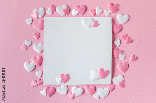 Valentines day concept. Greeting card with a pink and white hearts and space for text on a pink background. Top view. Flat lay. © Regina