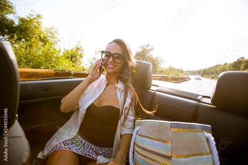 Woman uses mobile phone and...