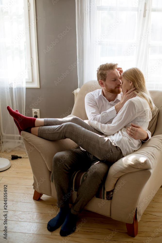 Young loving couple on the sofa