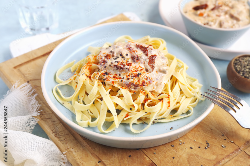 Italian tagliatelle with cream sauce from sun-dried tomatoes