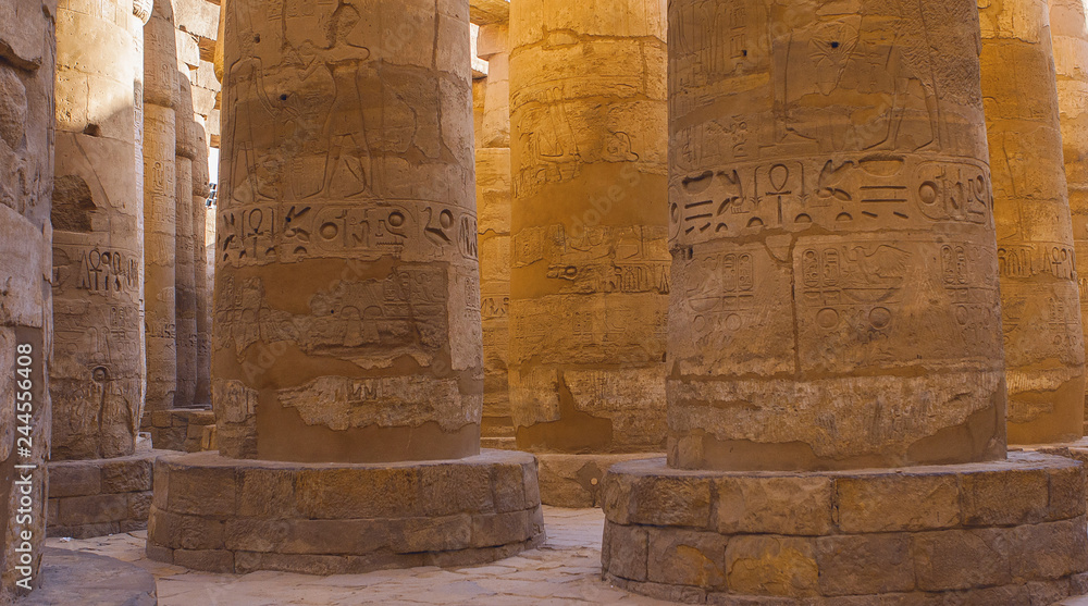 Karnak Temple, Colossal sculptures of ancient Egypt in the Nile Valley in Luxor, Embossed hieroglyphs on the wall Karnak Temple, Colossal sculptures of ancient Egypt in the Nile Valley in Luxor, Embossed hieroglyphs on the wall