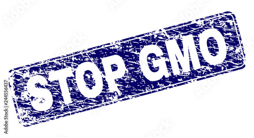 STOP GMO stamp seal print with distress texture. Seal shape is a rounded rectangle with frame. Blue vector rubber print of STOP GMO tag with corroded texture.