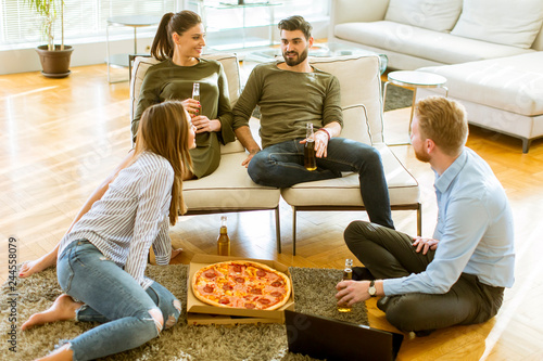 Young people eating pizza a...