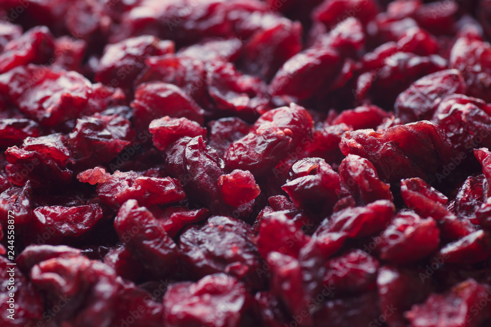 Delicious dried cranberries close-up in a wooden spoon. Organic food. Delicious dried cranberries close-up in a wooden spoon. Organic food.