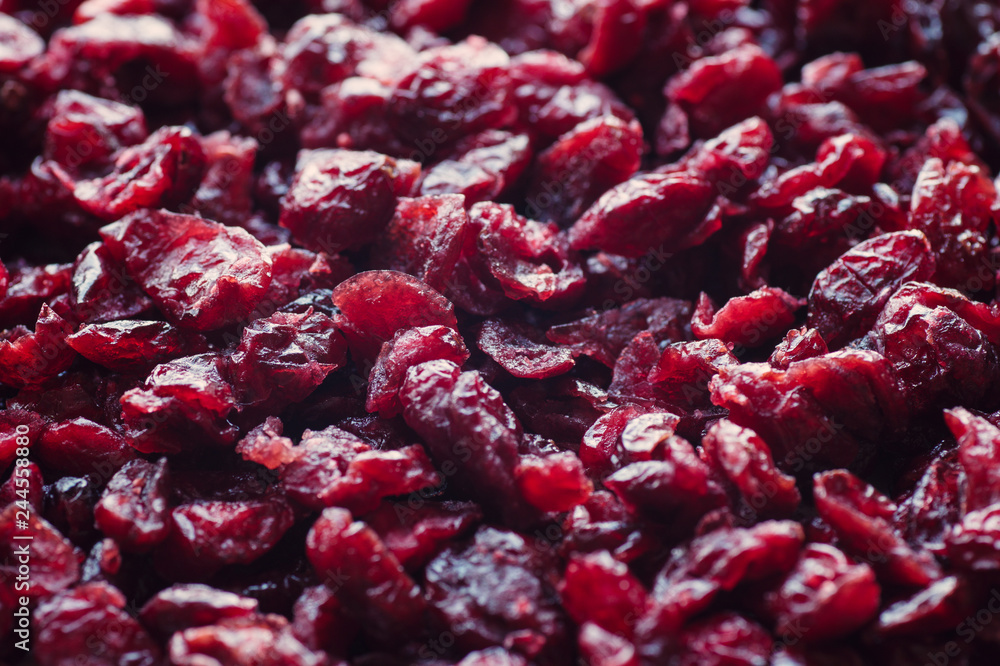 Delicious dried cranberries close-up in a wooden spoon. Organic food. Delicious dried cranberries close-up in a wooden spoon. Organic food.