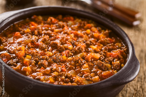 Homemade vegan bolognese sauce made with soy meat, fresh tomatoes, onion and garlic, served in rustic bowl (Selective Focus, Focus one third into the sauce) photo
