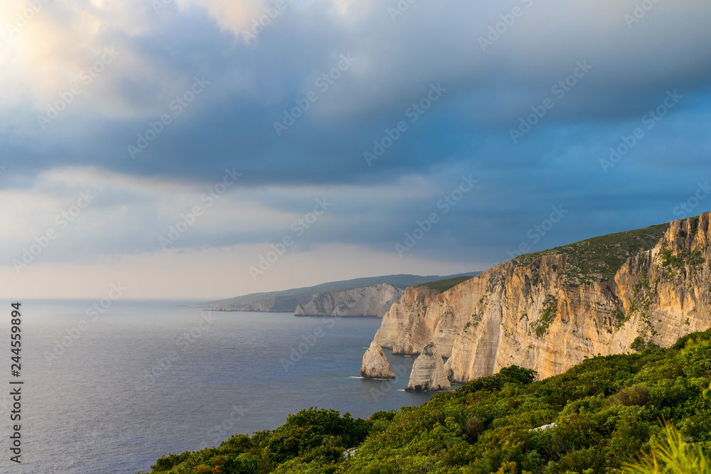 Greece, Zakynthos, Huge white chalk rock wall cliffs alon coastline of the island at sunset