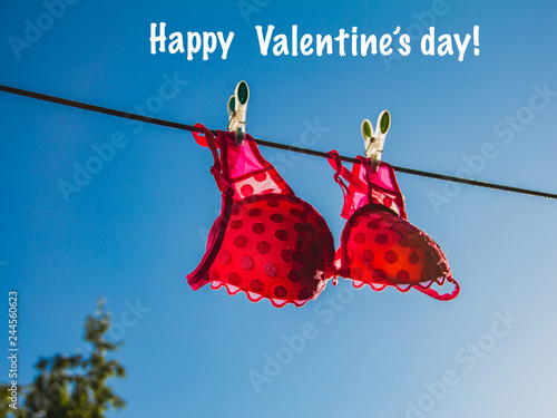 Pink lingerie on the clothesline in the open blue sky. Happy valentines day love concept. photo