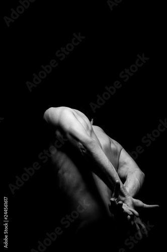 black and white photo hands in dramatic bend expression, studio photo on a dark background
