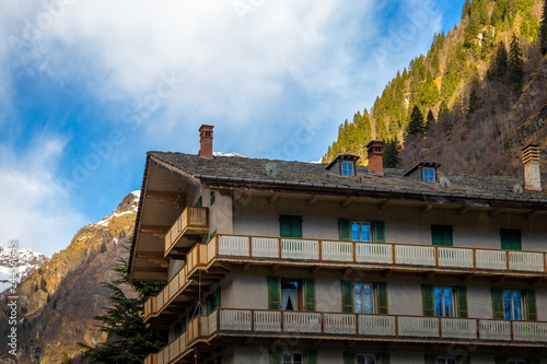 Mountain panorama with peaks, snow, villages, streams and trails