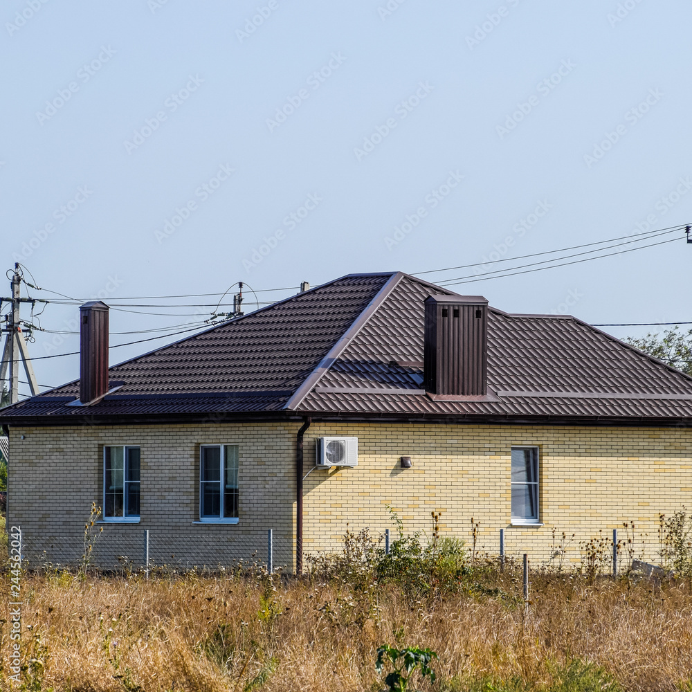 The house with plastic windows and a roof of corrugated sheet The house with plastic windows and a roof of corrugated sheet