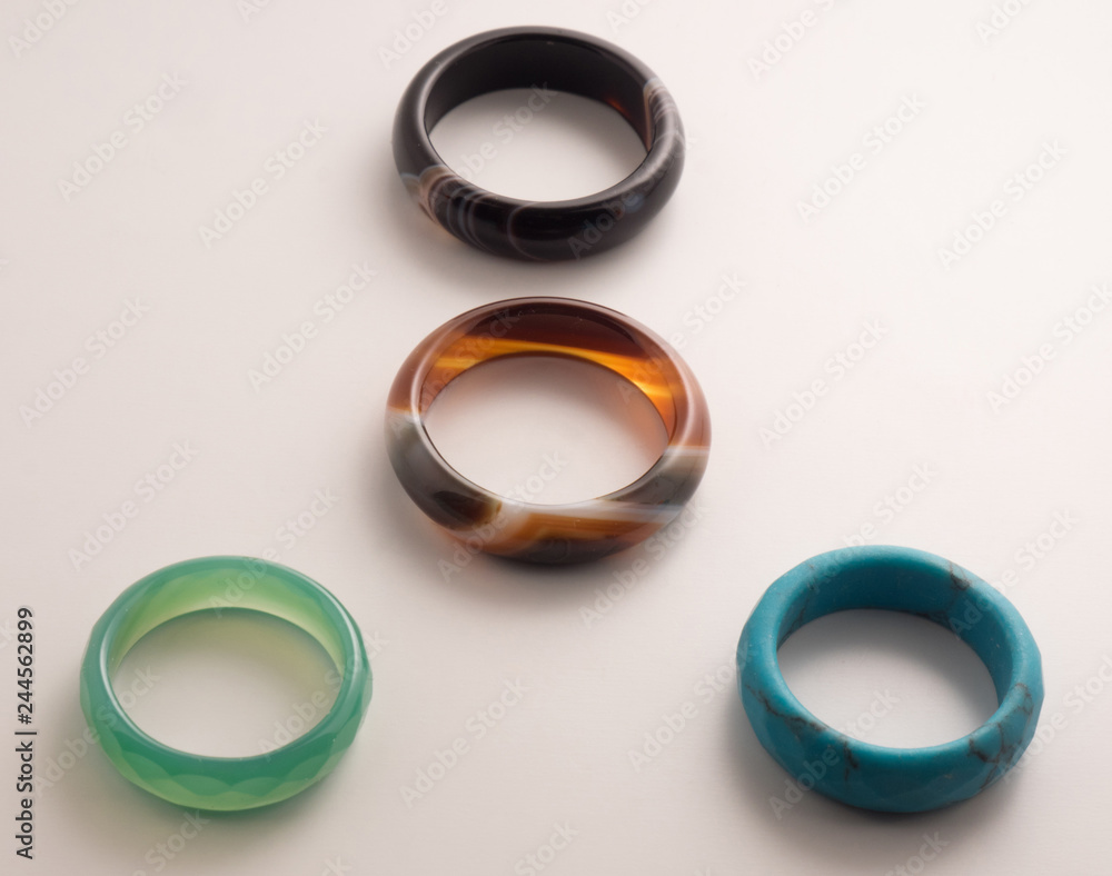 Four rings of colored stone on a white background Four rings of colored stone on a white background