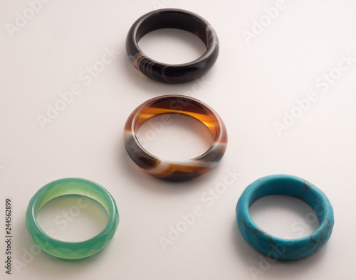 Four rings of colored stone on a white background