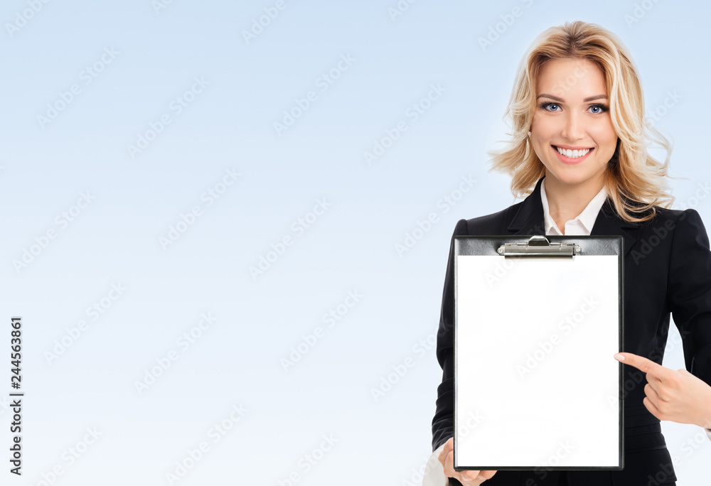 Fototapeta premium young businesswoman showing blank clipboard