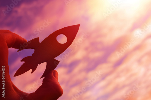 Quadro su tela rocket in the hand of a man on the background of the evening sky