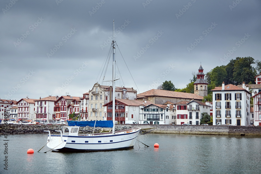 White Sailing yacht moored in the fishing port of Saint-Jean-de-Luz / Ciboure (France)