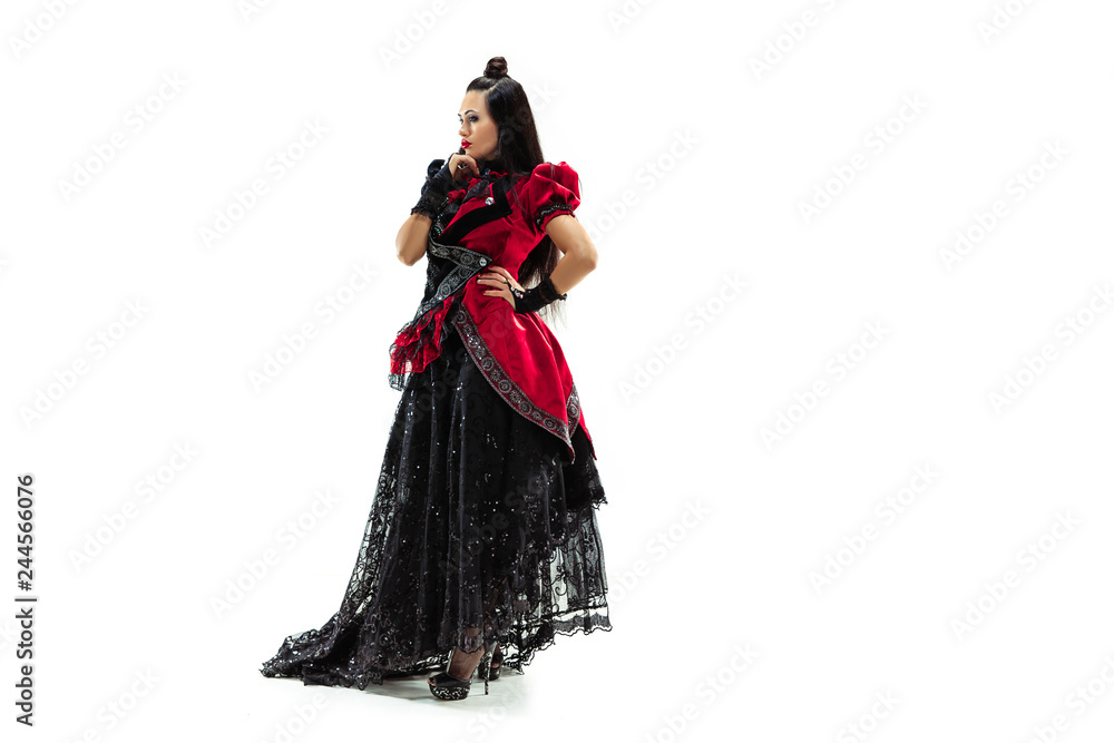 The young woman dressed in medieval style posing at studio as marquise. Fantasy, Antique, Renaissance concept The young woman dressed in medieval style posing at studio as marquise. Fantasy, Antique, Renaissance concept
