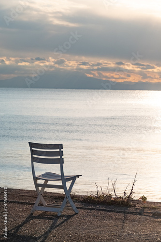 wooden chair on the beach © Makoto