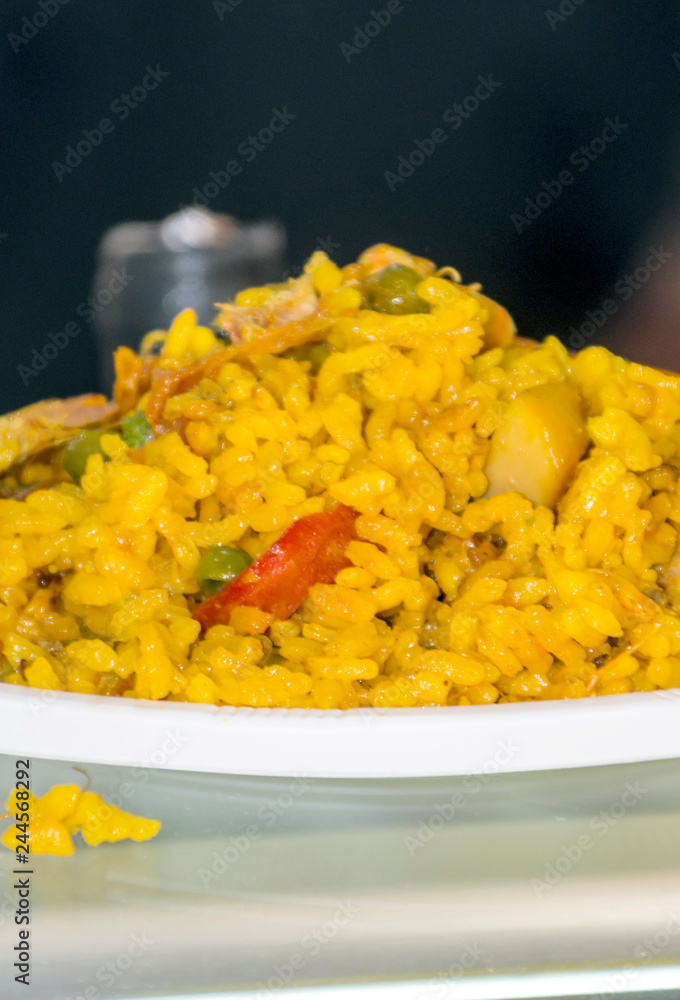 Paella served on a plate surrounded by blurred background Paella served on a plate surrounded by blurred background