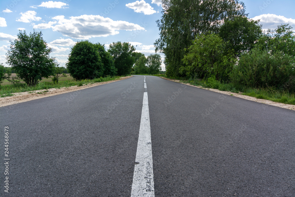 New smooth asphalt road in summer New smooth asphalt road in summer