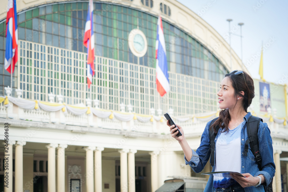 Asian woman traveling with mobile phone