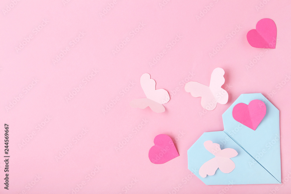 Paper hearts with butterfly on pink background