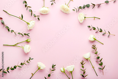 White rose flowers with green leafs on pink background