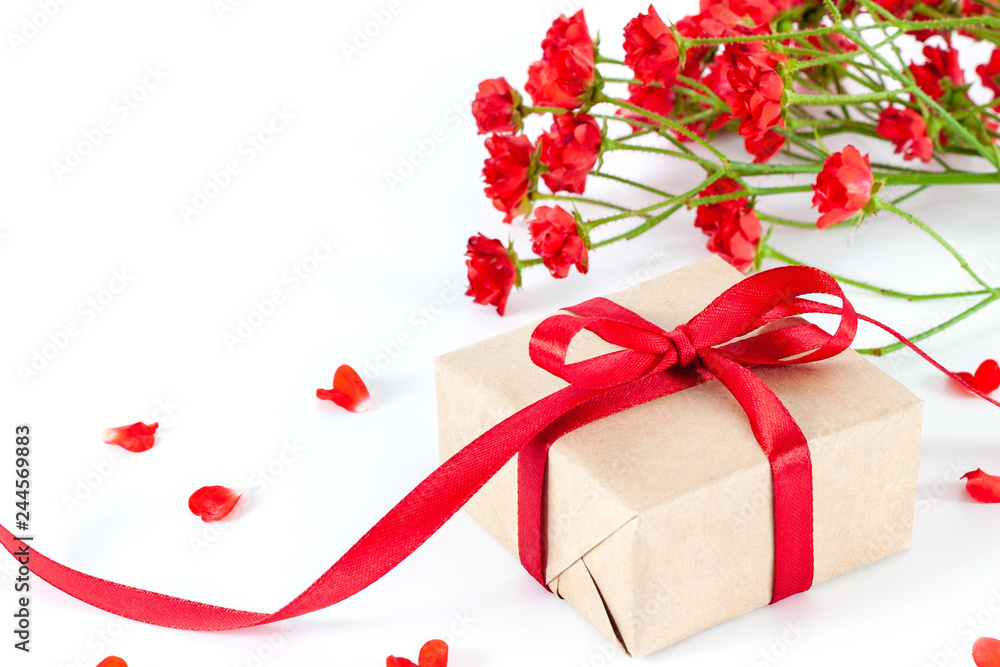 Present or gift box in a craft paper with gold ribbon bow