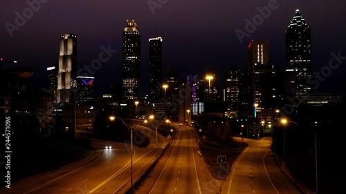 ATLANTA GEORGIA, January 20, 2019:  Light car traffic moving towards the Atlanta Georgia downtown modern skyline at night. USA