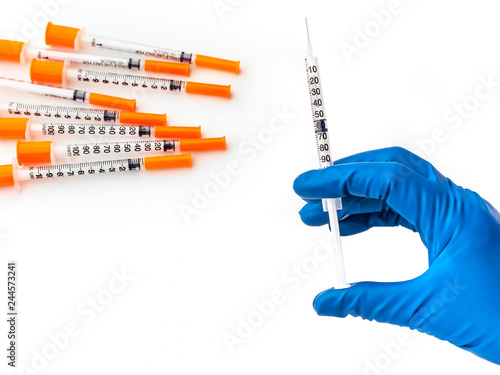 Obraz na plátne Doctor's hand in blue medical glove holding syringe with medical solution