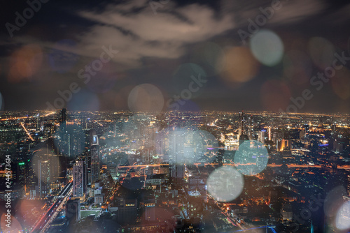 ฺNight scene of Bangkok cityscape with skyscraper and curve of Chao Praya river in the far background with Bokeh effect for nightlife concept / Cityscape concept / Nightlife