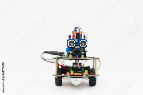 Hand made robot working on the arduino platform. White background. Free space for text. STEM education for children and teenagers, robotics and electronics. DIY. AI. STEAM.