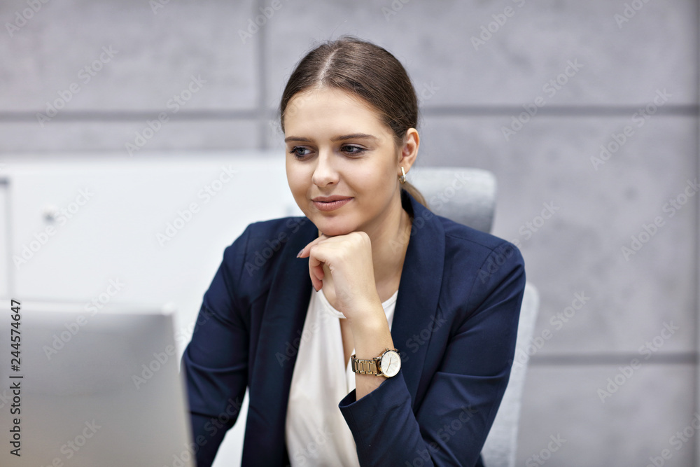 Close up portrait of attractive smiling businesswoman at workplace
