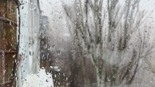 Rain drops sliding on window glass.