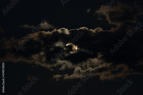 Full moon surrounded by clouds before the eclipse