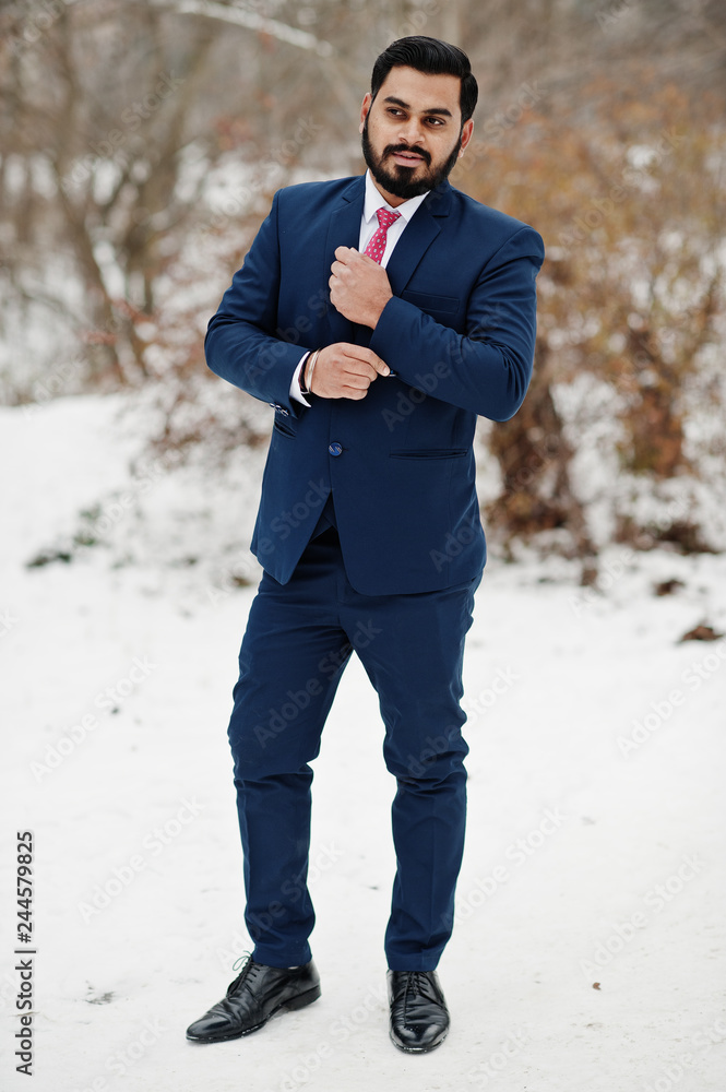 Stylish indian beard business man in suit posed at winter day outdoor. Stylish indian beard business man in suit posed at winter day outdoor.