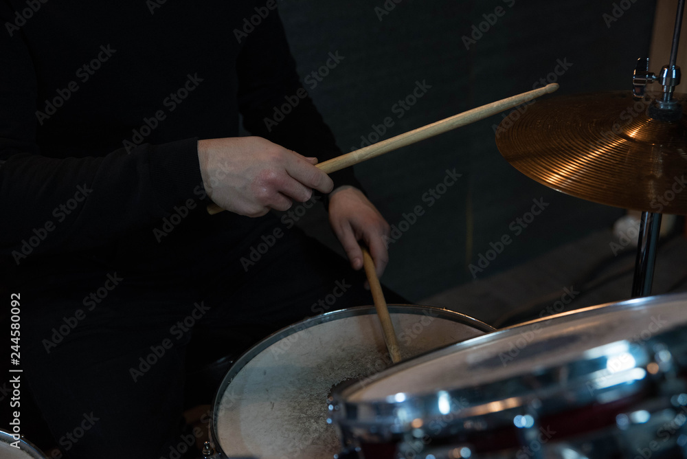 Professional drum set closeup. Drummer with drumsticks playing drums and cymbals, on the live music rock concert or in recording studio Professional drum set closeup. Drummer with drumsticks playing drums and cymbals, on the live music rock concert or in recording studio
