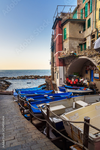 View of narrow street with boats and sea in Riomaggiore, Cinque Terre. Italy