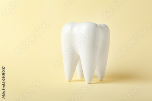 Fototapeta Naklejka Na Ścianę i Meble -  Ceramic model of tooth on color background. Space for text