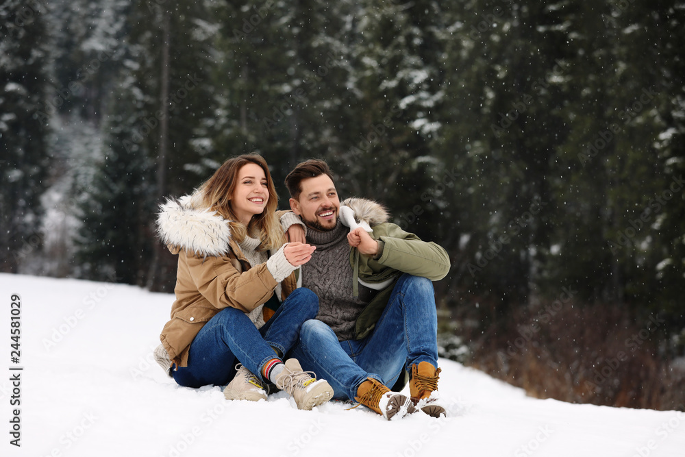 Fototapeta premium Couple spending time outdoors on snowy day. Winter vacation